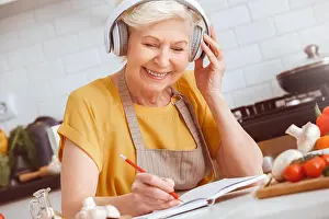 Grandma Prints: Older woman cooking, listen to music in mobile