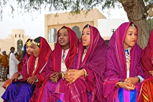 Oman Prints: Omani girls in traditional dress take a break during a cultural festival in Muscat