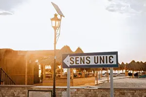 Street Light Prints: One-way sign on the seaside road near the beach