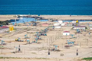 Petroleum Prints: Onshore oil field with derrick pumps on the Caspian coast in Azerbaijan