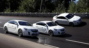 Three Opel Insignia OPC race along the racecourse at the new Opel testing center in Rodgau-Dudenhofen