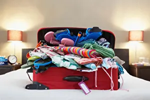Bright Colour Prints: Open suitcase on bed