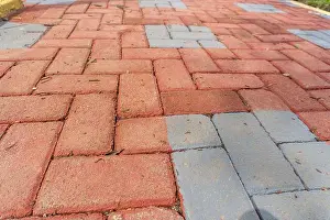Orange colored paving block bricks path in the park close up