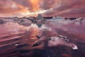 Images Dated 14th June 2016: Orange sunset and icebergs in Jokulsarlon glacial lagoon. Vatnajokull National Park