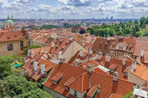 The orange terra cotta roofs of Prague's Malá Strana district stretch past St Nicholas Church to the Vltava River