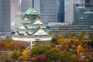 Osaka Castle with Japanese garden and city office building skyscraper at autumn season in Osaka, Japan. Japan tourism, history building, or tradition