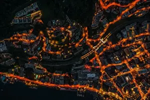 Aerial Cityscape Prints: Overhead aerial drone night shot of city street lights in Lugano, Switzerland