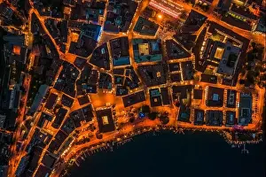 Aerial Cityscape Prints: Overhead aerial drone night shot of city street lights in Lugano, Switzerland
