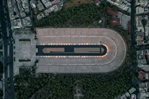 Gods View Prints: Overhead aerial drone shot of Panathenaic marble stadium with lights in dusk Pangrati