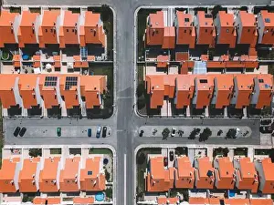 City Planning Prints: Overhead aerial drone shot showcasing a well-planned suburban area featuring red-tiled homes and organised streets