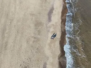 Outdoor Activity Prints: Overhead birds eye drone aerial view people walking on beach long shadows Great Yarmouth beach