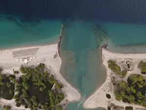 Surfers Prints: Overhead drone photo over the tropical blue ocean and the bay of Glarokavos in Paliouri