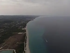 Surfers Prints: Overhead drone photo over the tropical blue ocean and the bay of Glarokavos in Paliouri