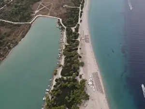 Surfers Prints: Overhead drone photo over the tropical blue ocean and the bay of Glarokavos in Paliouri