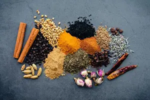 Dark Background Prints: Overhead View of Ras el Hanout Spice Mix Ingredients: Ingredients for a Moroccan spice mix made of dried herbs