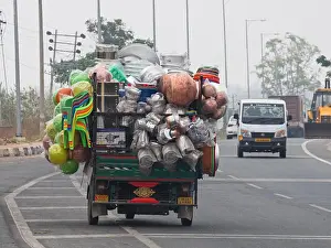 Excessive Prints: Overloaded commercial vehicle carrying household goods on a main highway south of Mysore