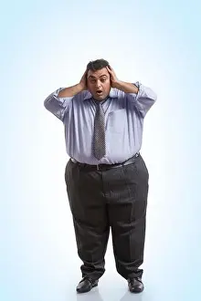 Fat Man Prints: Overweight man in formal clothes holding his head with both hands with an expression of shock