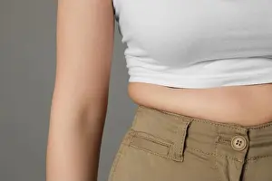 Tight Prints: Overweight woman in tight pants on grey background, closeup