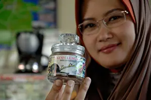 East Java Prints: Owner Luwakmas coffee industry Hj Yekti Murih Wiyati displays a package of Luwak Coffe in Kediri