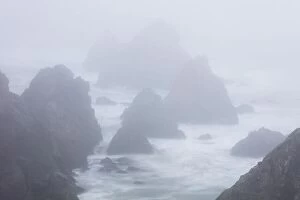 Aerial Landscape Collection: The Pacific Ocean crashes against sea stacks along the foggy seashore of Northern California