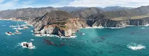The Pacific Ocean washes onto the beautiful seashore of California, not far south of Monterey. The Pacific Coast Highway runs right along this region