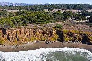 The Pacific Ocean washes against the rocky, scenic seashore of Central California in Morro Bay. This beautiful coastal region is known for landscapes