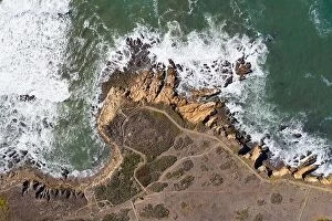 Aerial Landscape Collection: The Pacific Ocean washes against the rocky seashore of Central California in Morro Bay