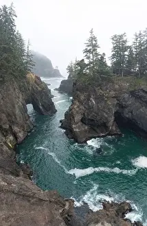 The Pacific Ocean washes against the scenic, rugged coastline of southern Oregon. This part of the Pacific Northwest is accessible via highway 101