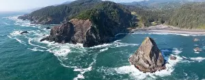 The Pacific Ocean washes against the scenic, rugged coastline of southern Oregon. This part of the Pacific Northwest is accessible via highway 101