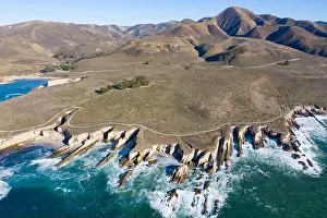 The Pacific Ocean washes against the scenic seashore of Central California in Morro Bay. This coastal region is known for its beautiful coastlines