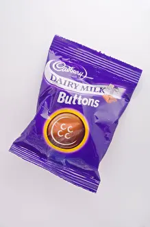 A packet of Cadburys dairy milk chocolate buttons snack made by cadbury