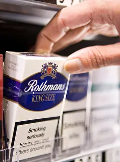 Cigarettes Prints: Packets of Rothmans cigarettes made by British American Tobacco sit on the shelf of a retail store