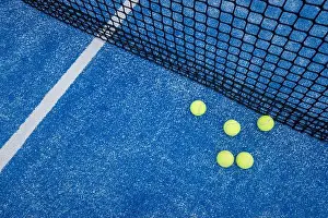 Turf Prints: five paddle tennis ball on the net of a blue paddle tennis court