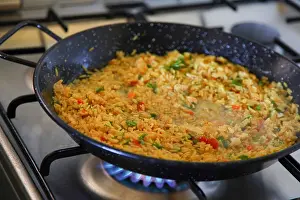 Valencian Prints: Paella, (Paeia) a Valencian rice dish cooking on a stove