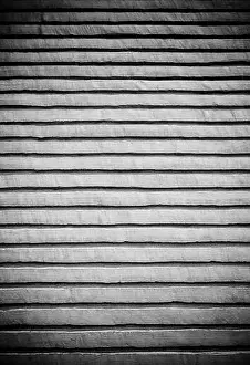 Faded Prints: Painted concrete wall detail of a street decoration, painted facade
