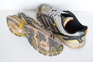 Outdoor Activity Prints: Pair of old Run and walking shoes worn out and with holes under the sole