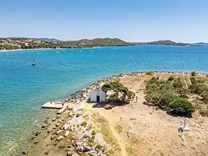 Pakostane, Croatia - July 27, 2024: Little island with little chapel near Pakostane city in Croatia