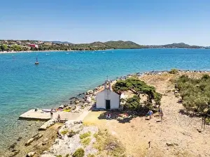 Pakostane, Croatia - July 27, 2024: Little island with little chapel near Pakostane city in Croatia