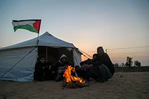 Gaza Prints: Palestinians dance the Dakba next to tents pitched by Palestinians on the Gaza border with Israel ahead of a six-week
