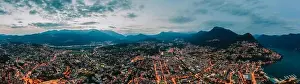 Aerial Cityscape Prints: Panorama aerial drone night shot of city street lights by lake in Lugano, Switzerland