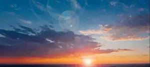 Lens Flare Prints: Panorama of a beautiful sky with the sun and lens flare on the clouds against the backdrop of a calm summer evening