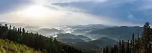 Low Clouds Prints: Panorama on cold cloudy weather over low hills covered with spruce evergreen forests in Rhodope Mountains against