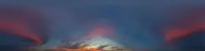 Panorama of a dark blue sunset sky with pink Cumulus clouds