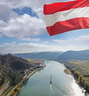 Panorama of Duernstein village with ship on Danube river during autumn in Austria, UNESCO