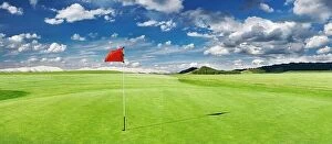 Landscape Collection: Panorama of golf course with red flag in a hole
