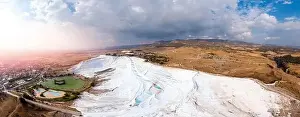 Panorama Natural travertine pools blue water in Pamukkale Turkey aerial top view with sunlight