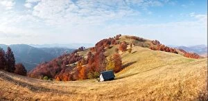 Images Dated 18th October 2019: Panorama of picturesque autumn meadow with wooden house and red beech trees in the Carpathian