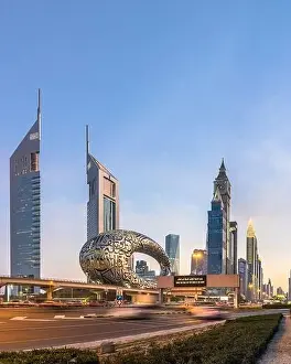 Dubai Skyline Prints: Panorama shot of Sheikh Zayed Road showing the new Museum of Future monument along with the Dubai skyline during blue
