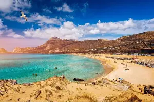 Panorama of turquoise beach Falasarna (Falassarna) in Crete with seagulls flying over