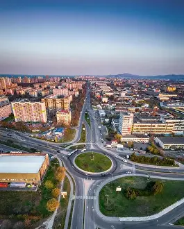 Panorama view of the road with a circular motion and a flower bed at sunset. Aerial photography